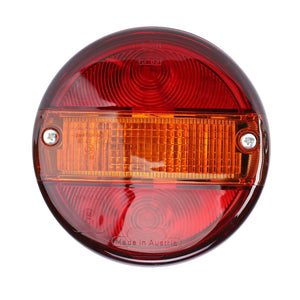 The AGCO Combination Light, Rear, Indicator & Brake (G716900020090) features red and amber sections, mounted with two screws, and labeled “Made in Austria,” ensuring optimal illumination. Perfect for Fendt Vario models, this 12V 5W & 12V 21W bulb assembly exemplifies AGCO Genuine Lighting Parts.