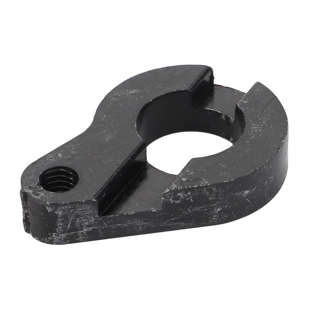 A black, worn metallic clamp piece featuring a central circular cutout and a threaded hole on one end can be referred to as an AGCO Plate - Acx3379290, though it lacks important SEO keywords in its product description.