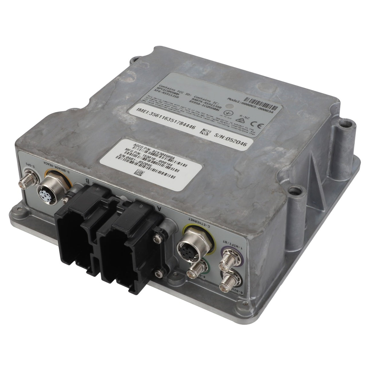 The AGCO Module - Acx304608A, a product from AGCO, is a metal electronic control module with various ports and connectors. It features data labels with printed numbers and barcodes, and its rectangular unit boasts a rugged design.