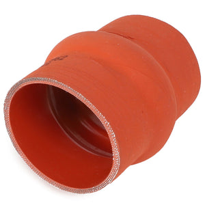 The AGCO HOSE - AG121551 is a red silicone hose reducer with a smooth outer surface and reinforced inner lining, designed for maximum durability in connecting pipes of different diameters within engine compartments for automotive or industrial applications. Ideal as a replacement for AGCO hoses.