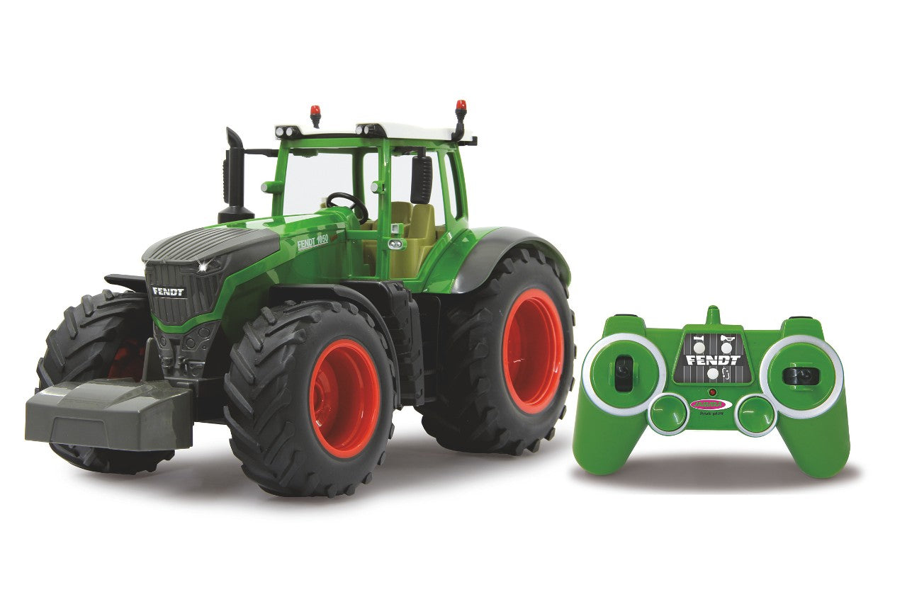 A green AGCO | Fendt 1050 Vario 1:16 Remote Control Tractor by Jamara, featuring large tires and orange rims, is placed next to its matching green controller. The toy boasts detailed craftsmanship reminiscent of the real Fendt 1050 Vario.