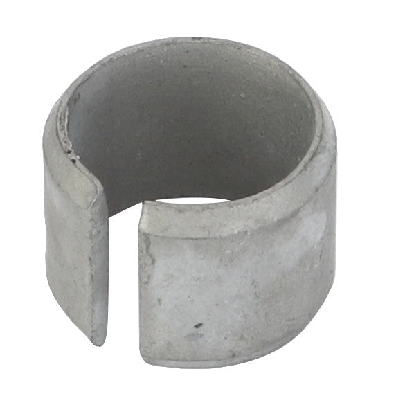 The AGCO Tensioner Bush - F119200210340 is a cylindrical metal ring with a slit opening, potentially used as a component part.