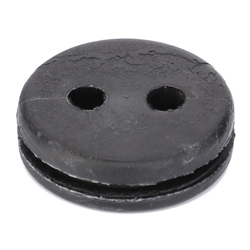 A black, round rubber mounting from AGCO (F100003361809) featuring two holes and a distinct groove encircling its circumference.