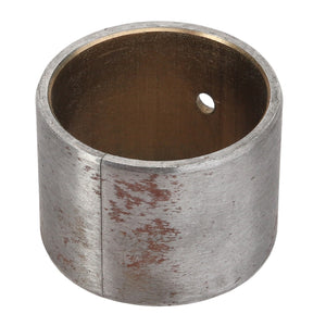 The AGCO BUSH - ACY1514130, a cylindrical metal bushing from the AGCO brand, features a small hole and a slightly worn, tarnished surface, reflecting its status due to the lack of current product description information.