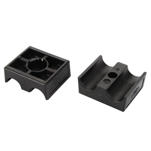 The AGCO | Clamp - Acx0133180 consists of two black plastic mounts designed for holding and securing cylindrical objects, displayed in different orientations. The left mount features a circular holder, while the right has a semi-circular groove. No current product description information is available from AGCO.