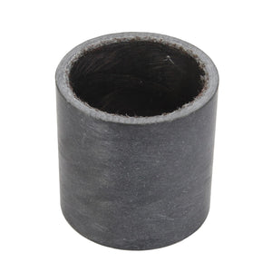 The AGCO Bush - Acw1125770 is a cylindrical, black rubber bushing with a hollow center, presented from an angle that highlights its circular opening.