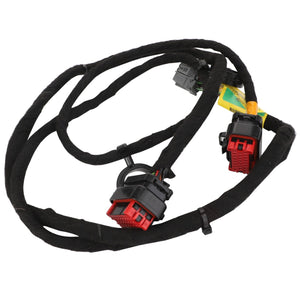 The AGCO Harness - Acw749263A, suitable for Valtra Models, is shown coiled with several labels attached. This black cable harness includes multiple connectors, featuring two red and black connectors.