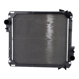 Image of an AGCO | Radiator, No Cap - 3781115M1 with multiple cooling fins and two black inlet and outlet pipes on the sides. The radiator, designed to meet performance requirements, has a rectangular shape and is viewed from the front. Suitable for Massey Ferguson Models.