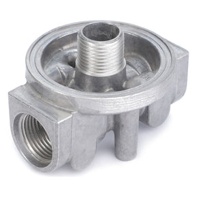 The "Fuel Filter Head Housing - 6223538M1" by AGCO is a metallic component with threaded openings, likely part of a hydraulic system or plumbing assembly.