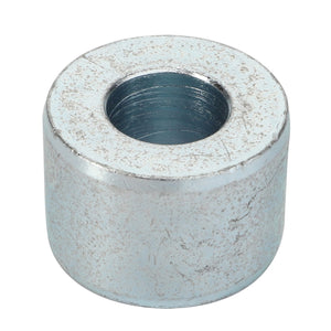 The AGCO | Bush - Acp0323710, a metallic cylindrical spacer featuring a central hole, shows signs of wear and surface scratches.