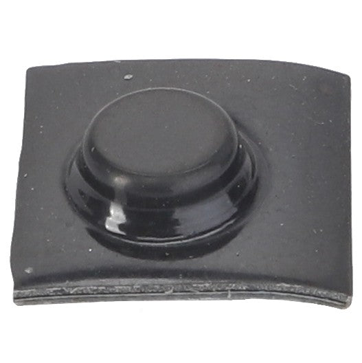 The AGCO | Bumper - Acw1042520, a small black plastic component with a circular protrusion in the middle, set on a slightly curved rectangular base, is commonly used in Massey Ferguson Models.