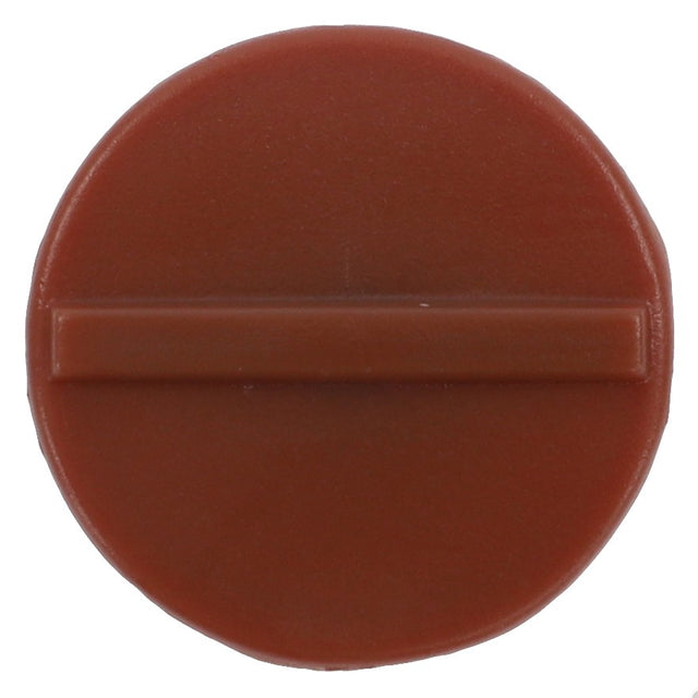 The AGCO | Padding - 4389713M1 is a circular, brown plastic cap featuring a horizontal raised bar across the center, and is compatible with Massey Ferguson Models.