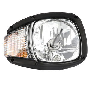 Close-up of the AGCO WARNING DECAL - ACP0538090 headlight, featuring a clear lens with a black frame, reflective surface, and amber-colored section, ensuring optimum illumination for superior visibility.