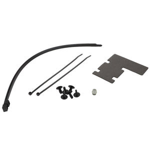 Several black cable ties, a curved black rod, four small black buttons, a grey cylindrical item, and a flat dark grey piece with cutouts from the AGCO | Small Parts Kit - F930500030910 are laid out on a white surface, resembling the meticulous organization found in Fendt Farmer equipment assembly.