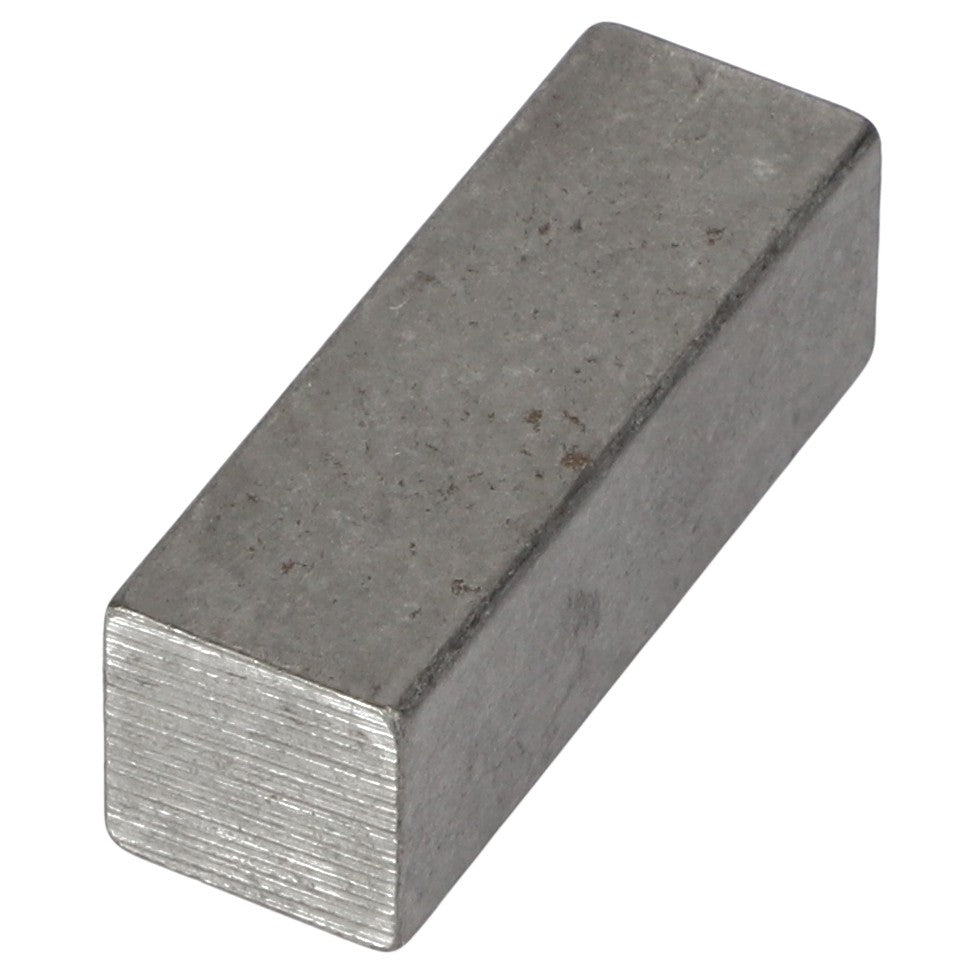 The AGCO | KEY - AG714891 is a rectangular metallic block with a dull, rough surface and visible texture on the ends.