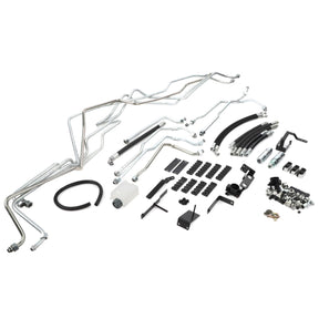 The AGCO Hydraulic Kit - Acp0633630 features an assortment of metal tubes, rubber hoses, connectors, and brackets arranged neatly on a white background.