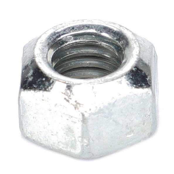 A close-up of the AGCO | Nut - X434102440000, a hexagonal metal nut with internal threading, similar to those used in conjunction with a bolt for fastening in Fendt Models' Vario S4 machinery.