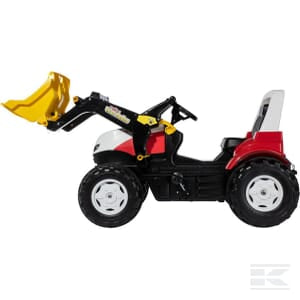 A small toy tractor, the Pedal tractor Steyr 6300 Terrus CTV - R710041 by Rolly Toys, with a red and white body, featuring an adjustable seat and a yellow front loader bucket, is shown against a white background.