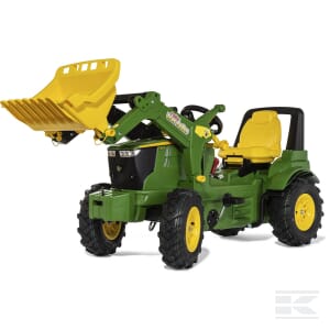 A green John Deere 7310R toy tractor by Rolly Toys, featuring a yellow front loader bucket and a yellow seat, designed for children.