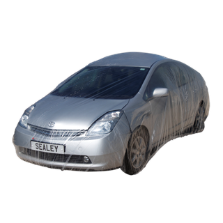 A silver car wrapped in the Sealey Temporary Universal Car Cover Large (TDCCL) with a license plate reading "SEALEY 1"—ideal for bodyshops, this disposable full car cover protects the vehicle from scratches.