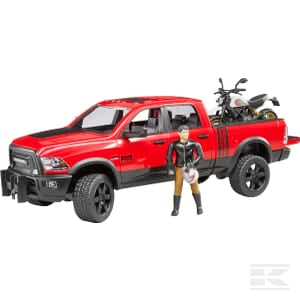 The Bruder Ram 2500 + Ducati racer (U02502) scale model features a red pickup truck with black details and a miniature motorcycle loaded in the truck bed. A small toy figure stands beside the truck, dressed in a black jacket and holding a helmet.