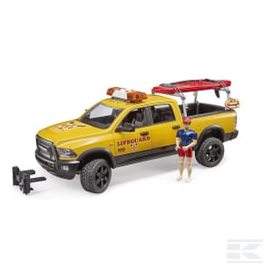 A Bruder RAM 2500 Power Wagon Life Guard toy (model U02506) featuring a yellow truck with surfboards on top, accompanied by a small figurine dressed in lifeguard attire.