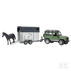 The Bruder Land Rover Defor with Horse Box - U02592 is a toy set that includes a green Land Rover SUV equipped with a roof rack, towing a white horse trailer. A black toy horse is positioned halfway out of the trailer.