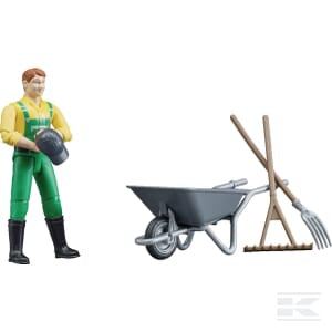 The Bruder Figure Set Farmer with Accessories (U62610) features a plastic figurine of a farmer dressed in a yellow shirt and green overalls, holding a bucket. The set also includes a silver wheelbarrow, pitchfork, and rake. Expertly crafted at a 1:16 scale, it is ideal for detailed dioramas or imaginative play.