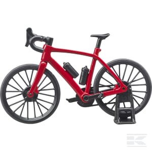 The Bruder Road bike with cyclist - U63110, featuring a sleek red racing design and two water bottles, is set up on a stationary bike trainer, making it perfect for the dedicated cyclist who enjoys both indoor and outdoor cycling.