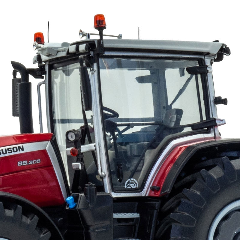 A close-up view of the cabin and driver's seat inside a red Limited Edition Massey Ferguson 8S.305 farming tractor with black and white accents from JMCE DEALS. Winner Tractor of the Year 2021, this tractor boasts large black tires with light gray rims, clear cabin windows, and safety lights mounted on top of the cabin.