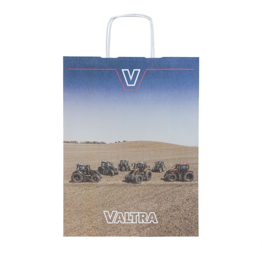 The Valtra Paper Gift Bag - V4280123 by AGCO is a stylish blue gift bag featuring an image of multiple tractors in a field. It has the word "Valtra" at the bottom in white text and the letter "V" prominently displayed at the top center.