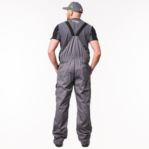 A man viewed from behind wearing a pair of dark gray waterproof overalls with black suspenders, a black t-shirt, and a gray cap, against a plain white background.