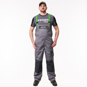 A man wearing gray Fendi work overalls with black knee panels, green shoulder straps, and a black Fendi Pro1 T-shirt, standing against a plain white background.