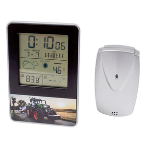 The AGCO Fendt Weather Station (X991021061000) displays current temperatures, humidity, moon phase, and weather forecast. It also doubles as an electronic desk organizer by showing the time and date. A separate white sensor unit is included.