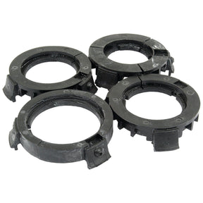 Four black plastic washer guides with grooves, distinctly arranged in a cluster on a white background, provide an efficient solution akin to Sparex PAK-PTO Bearings Eco-Small (Sparex Part No. S.10470).
