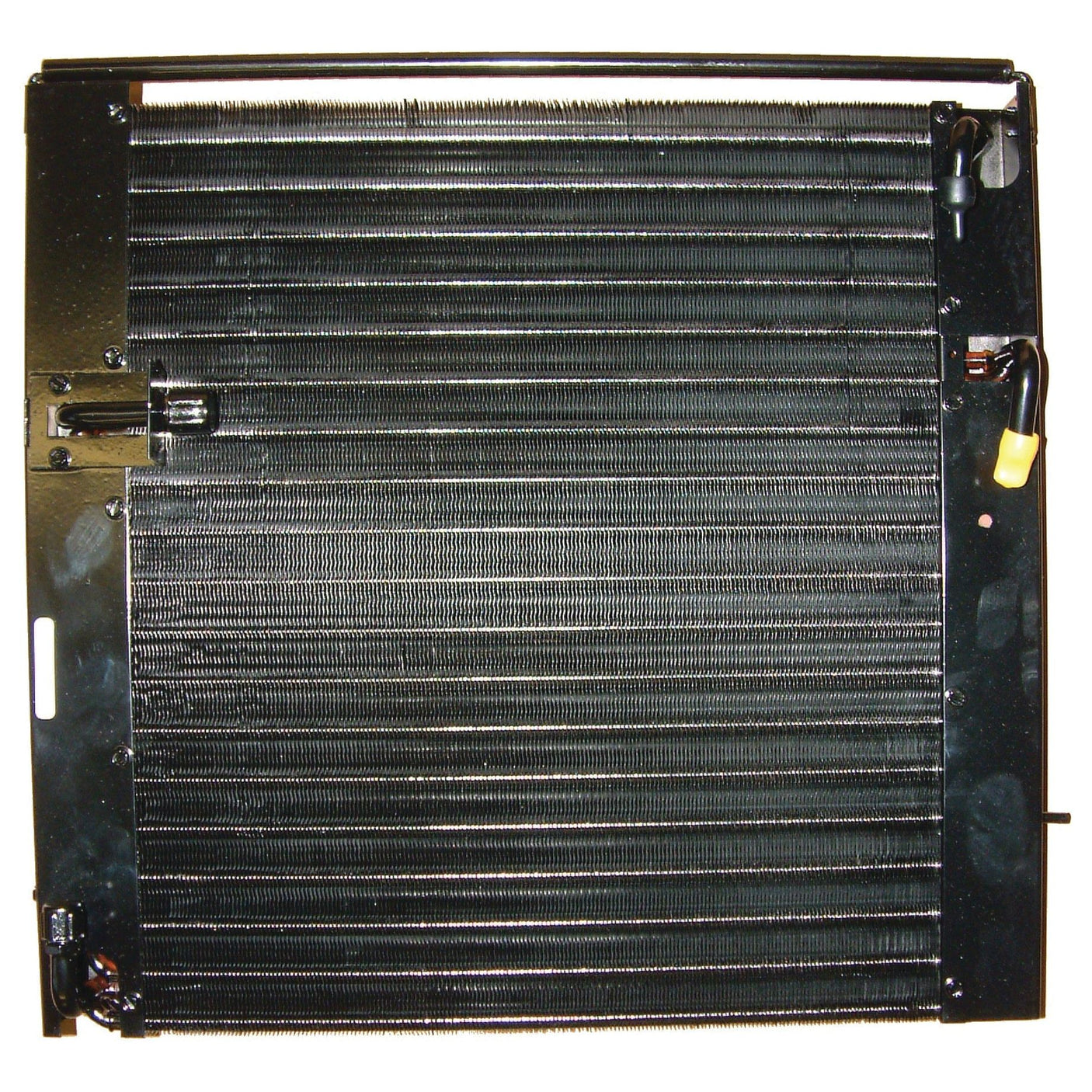 Close-up image of a Sparex Condenser - S.106674, which features a black radiator grille with fine metal fins and several connecting pipes. The design, similar to the oil cooler found in many Ford New Holland models, has a rectangular layout with visible pipes and fittings on the sides, showcasing Sparex quality.