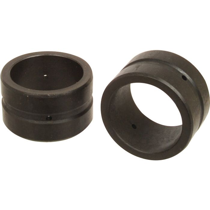 Two black cylindrical metal rings, closely resembling Sparex Synchro Sleeve Gears (Sparex Part No.S.108280), each featuring a small hole and a groove around the circumference. One ring is standing upright, while the other is positioned lying on its side.