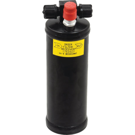 The Sparex Filter Drier - S.137918 is a black cylindrical unit featuring two valves on top, one of which has a red cap. A yellow label on the side indicates directional flow: in and out. Suitable for various HVAC systems, it includes essential manufacture information to ensure seamless integration and optimal performance.