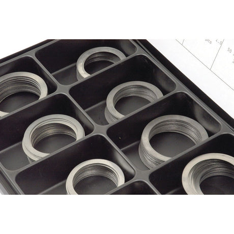 Close-up of a black plastic organizer box containing multiple circular Metric Shim Washers (ID: 15-45mm, OD: 22-55mm, DIN Standard No. DIN 988) in separate compartments, perfect for Sparex enthusiasts.