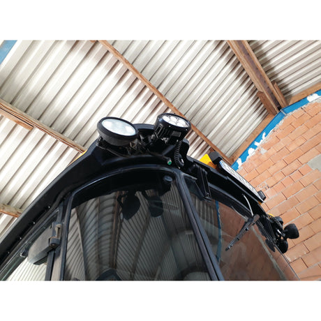 Close-up view of Sparex LED Work Light (Cree High Power), boasting 10000 Lumens Raw, mounted beneath a corrugated metal roof and adjacent to a brick wall.