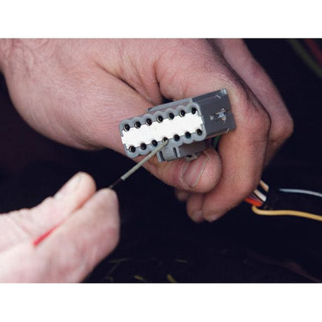 A person holding a gray electrical connector while another hand with a Sparex Super hard Diamond-Coated Round Micro File (S.151751) works on it.