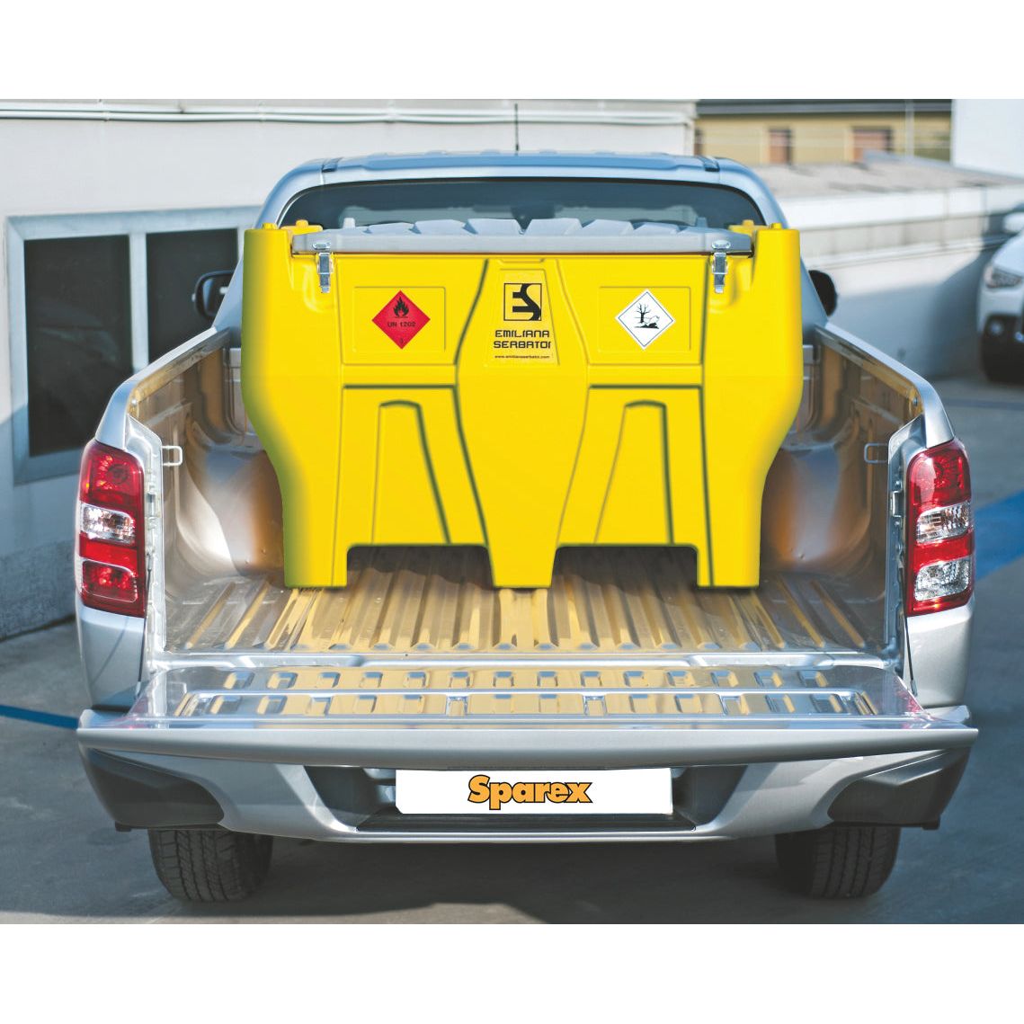 A yellow Sparex Carrytank Pickup - 440L - Diesel - 12V (DC) (S.163021) with hazard symbols and an electric pump is secured in the bed of a silver pickup truck.