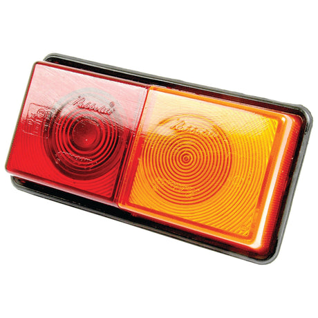 Close-up of a rectangular Sparex Rear Combination Light (12V, S.21865) featuring a red lens on the left and an amber lens on the right, both with circular patterns. The halogen Brake/Tail/Indicator lights ensure optimal visibility.