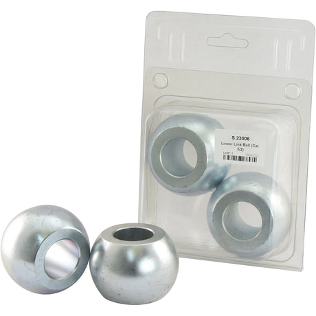 Image of four metallic lower link balls made from 20Mncr5 Steel, with three placed in front and one inside clear packaging labeled "Lower Link Ball (Cat. 3/2) - S.23006".