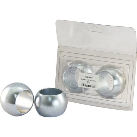 Two silver spherical objects, identified as lower link balls, are displayed next to a plastic package containing two more. The label indicates the model number S.23058 and an inner diameter (ID) of 1 7/16''. These parts are from the brand Sparex and specifically named Lower Link Ball (Cat. 2/3).