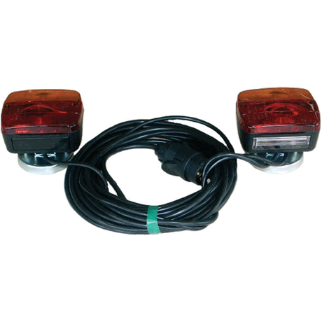 Two rectangular Halogen Lighting Set with red lenses, connected by a 7-meter long black cable wrapped in a coil and secured with a green twist tie. Each light features a magnetic fixing for easy attachment and uses halogen bulbs for enhanced visibility. This set is under the Sparex brand and has a maximum extension of 4 meters. Product code: S.26170.