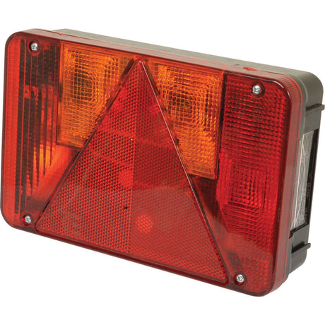 A rectangular Rear Combination Light by Sparex, featuring both red and amber colors, a central reflective triangle, and multiple halogen bulbs designed for 12V systems, is shown against a plain background. This light performs six functions: Brake, Tail, Indicator, Fog, Number Plate illumination, and Reflector. The spare part number is S.26657.