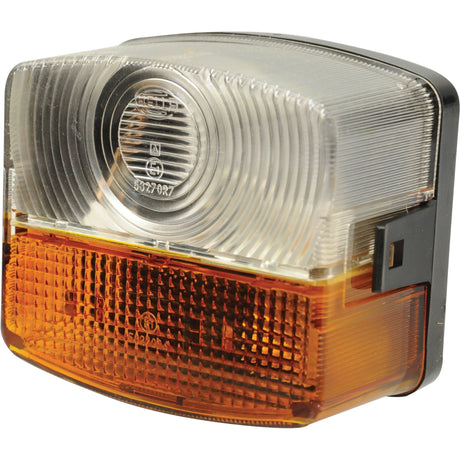 Close-up of the Sparex Front Combination Light (Halogen), 12/24V, LH, Straight - S.29827, featuring a clear upper section and an amber lower section. This rectangular light has curved edges and a textured polycarbonate lens material.