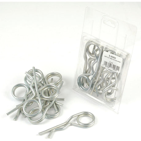 A collection of metallic hairpin cotter pins, including several loose Sparex Double Wound Grip Clips on the left and a sealed plastic package containing more clips (Sparex Part No.S.30262, Ø5mm x 110mm, Agripak 10 pcs.) on the right.