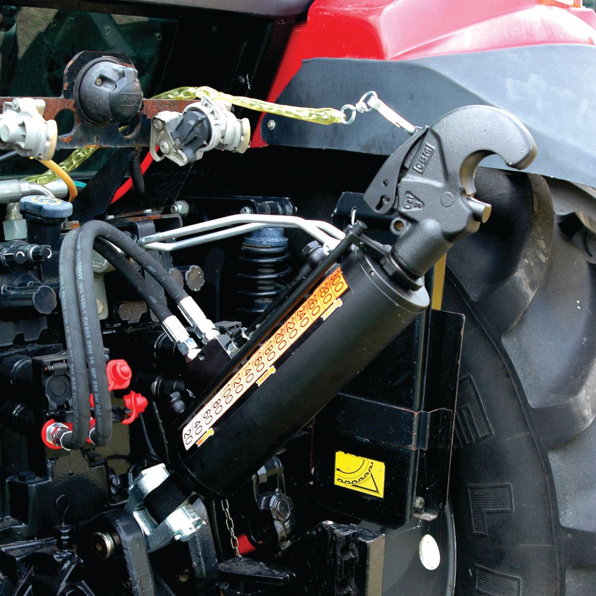 Close-up of a Sparex Hydraulic Top Link (Cat.2/3) Knuckle and Q.R CBM Hook, attached to a piece of Claas ARION tractor equipment, with visible hoses, cables, and adjustment gears. The cylinder, which has a bore diameter of 90mm and a minimum length of 650mm, features a sticker with symbols and instructions. The product is identified by Sparex Part No.S.331202.